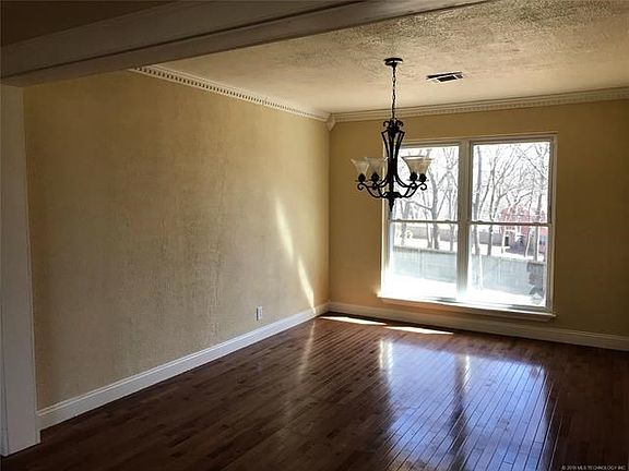 Formal dining room with updated paint and detailed crown molding!