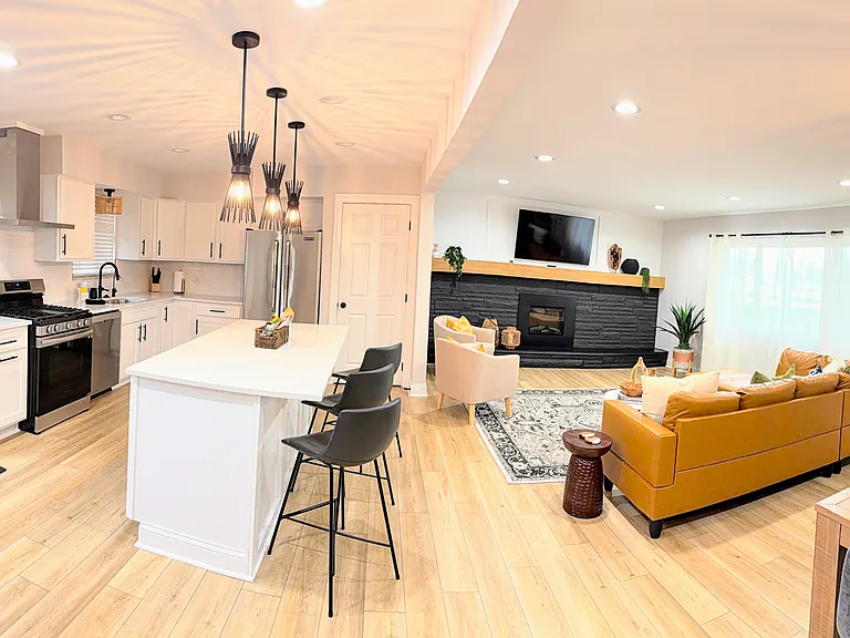 Gourmet kitchen with pots, pans and cooking utensils.