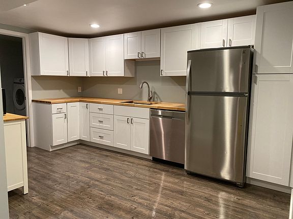 Kitchenette with new stainless appliances and butcherblock countertops