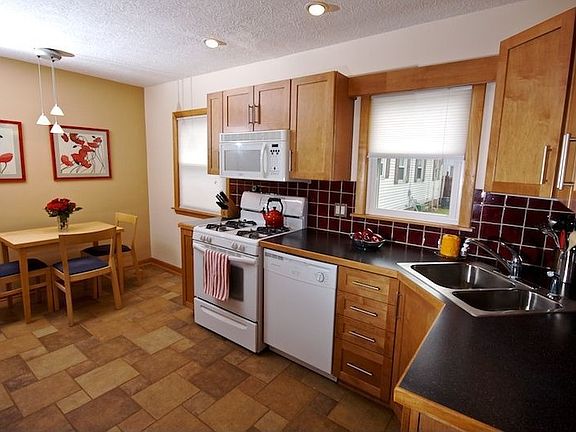 Kitchen with tile floor and kraftmaid cabinets