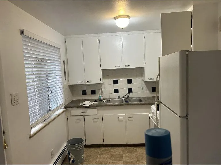 Sunny kitchen with lots of cabinets and gas stove