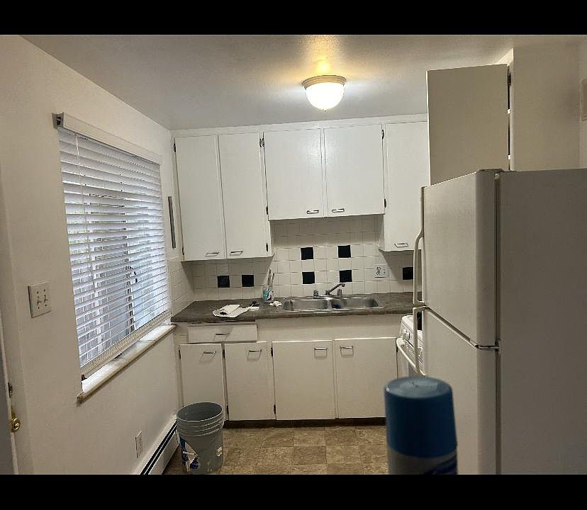 Sunny kitchen with lots of cabinets and gas stove