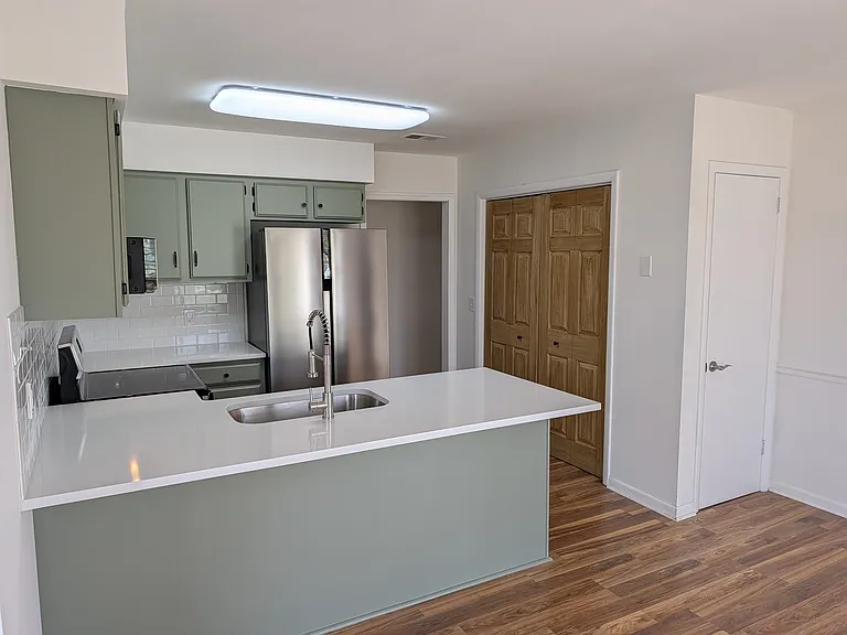 View of kitchen. Note second storage closet or pantry.
