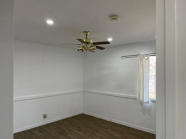 large bed room with ceiling fan