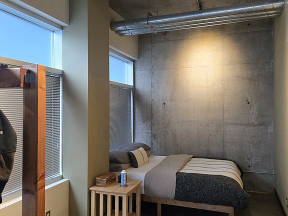 Bedroom Cove with Real Concrete Accent Wall. Prior tenants recommend: Sliding Hanging Barn Door for privacy (available on Amazon & Etsy).