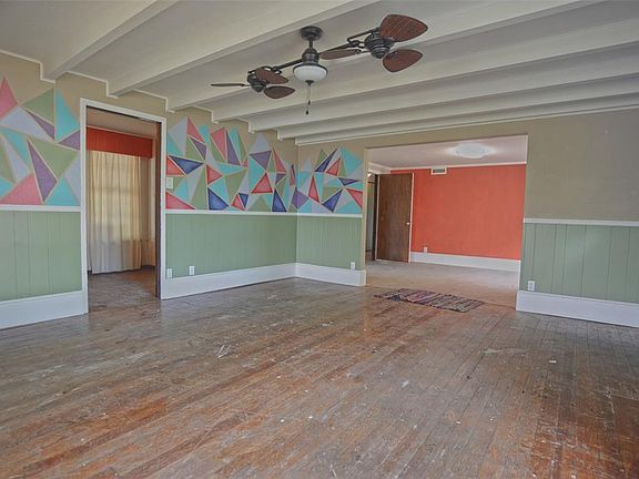 Alternate view of entry living room with dining room in right background.
