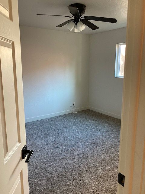 View of entry to bedroom on main level to be rented. New light fixture and window, fresh paint and carpet.