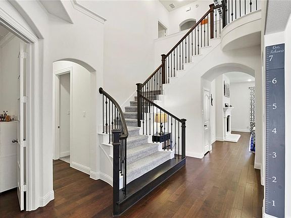 Grand Entry with Staircase with Wood Step-up and Iron Balusters