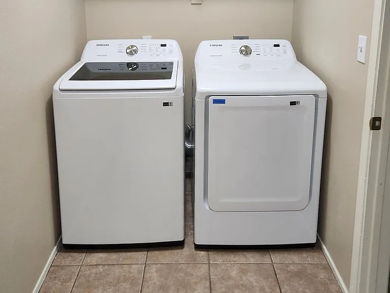 Laundry room with new washer/dryer.
