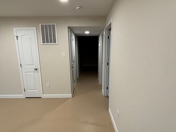 Front door, to the right is living room area and hallway leading to kitchen, bedrooms.
