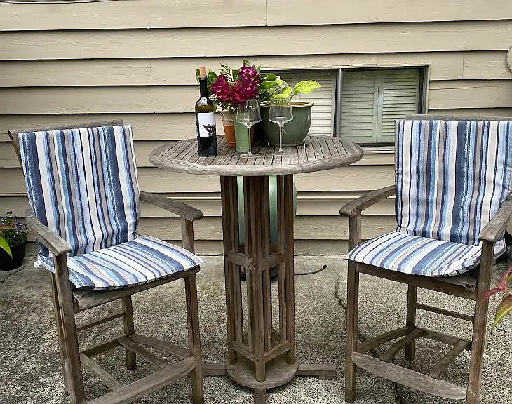 Soak up the sun while sipping a glass of wine and enjoying the garden view at this hightop table and chairs. Also found on the patio just outside of the entrance door.