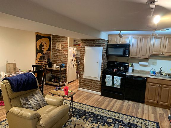 Living room and small kitchen with built in microwave, dishwasher etc.