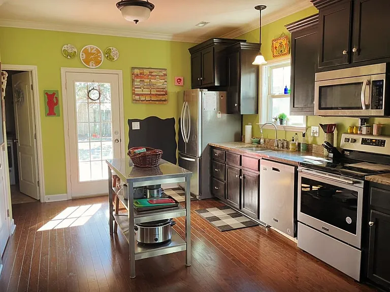 Kitchen with new dishwasher and stove / oven / range. Fun washable chalkboards. Sunny southern facing porch and fenced yard can be monitored from kitchen.