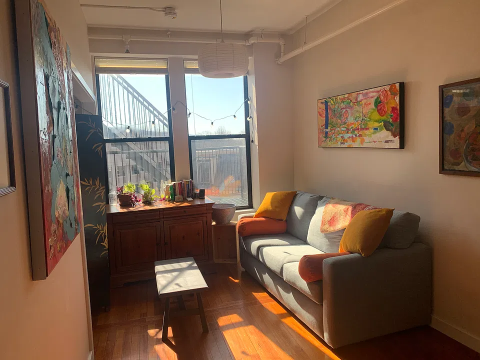 Living room with foldout couch and windows viewing Mt Tom.