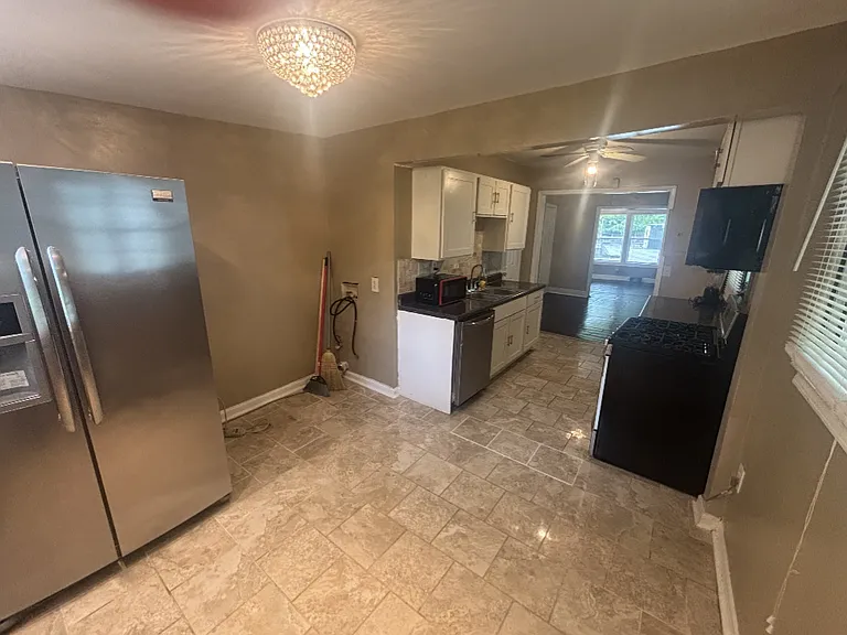 Washer/Dryer Area with Connections next to Refrigerator.