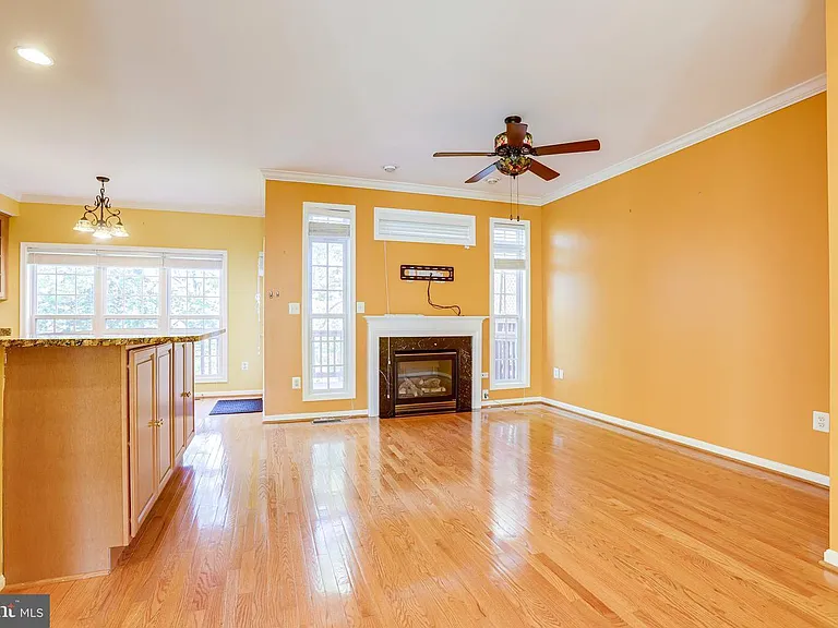 family room with luxury fan/techy tv mount and upgraded cabinet space
