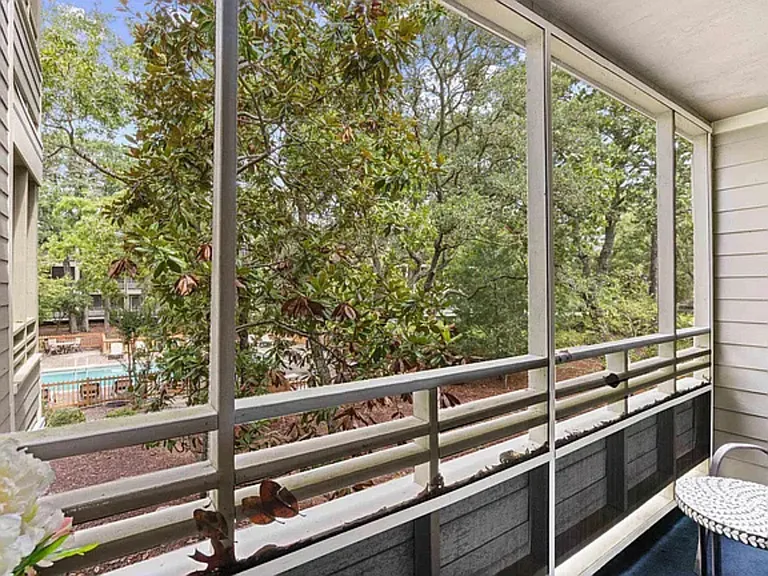 Balcony overlooking the trees and pool