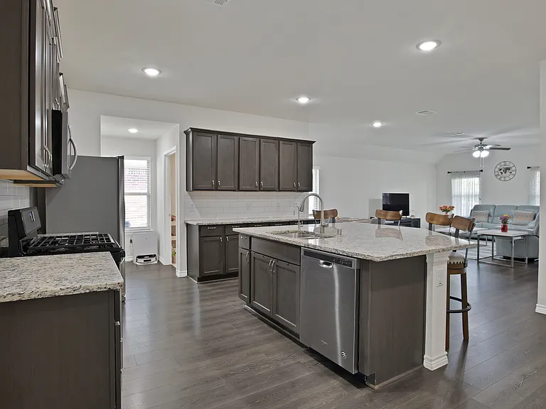 An open floor plan design overlooking the kitchen, dining area, and living areas