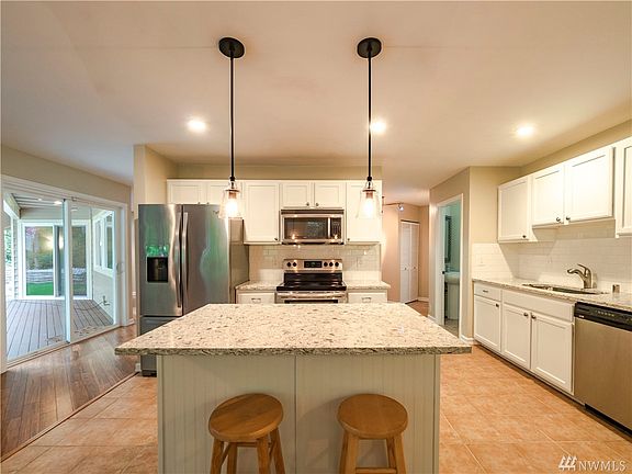 Gorgeous kitchen. Covered back porch for year round all-weather use. Large slider from the Kitchen and also the Master Bedroom has slider door to access the porch.
