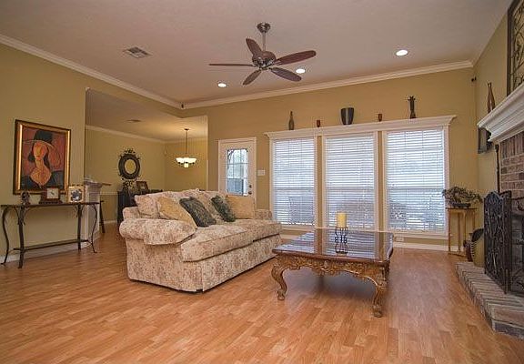Gleaming wood floors lead back to the wall of windows in the living room