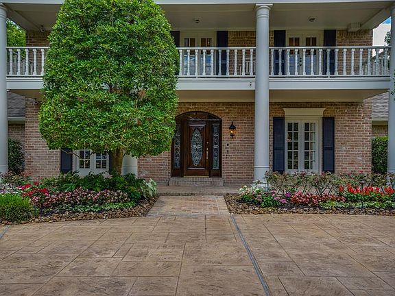 Gorgeous curb appeal with manincured gardens and pretty architecture. Leaded glass front door and floor to ceiling windows will greet you. Welcome home!