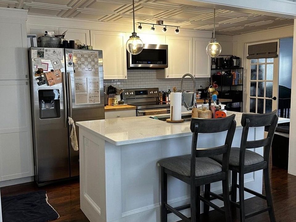 Kitchen with stainless steel appliances, dishwasher and microwave