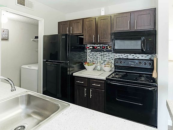 Experience the elegance of this contemporary kitchen, combining style with functionality.