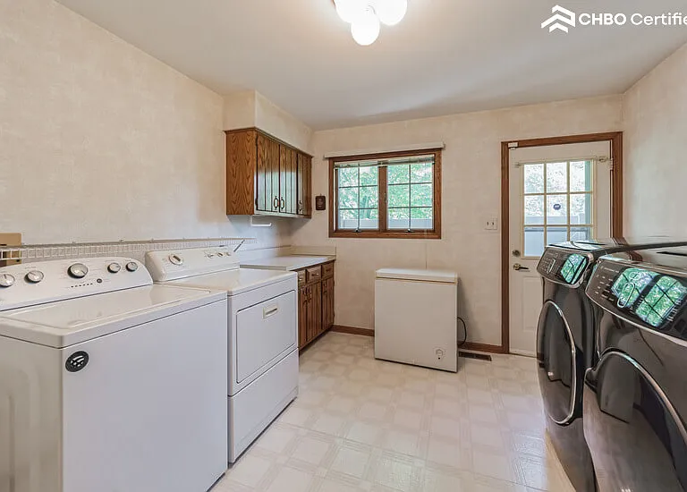 Laundry Room- chest freezer, dog run exit door, utility sink