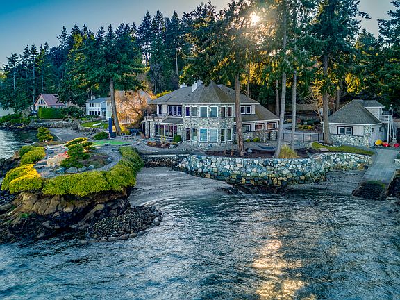 An idyllic waterfront lifestyle and setting with panoramic 240+ degree views, a sandy beach area, and a boat ramp!