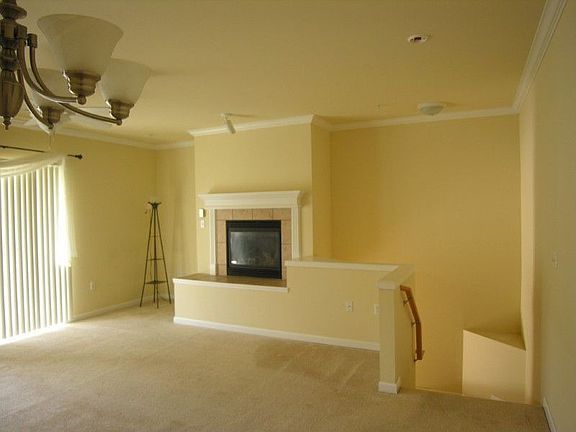 Living room with gas log fireplace and slider to bacony.