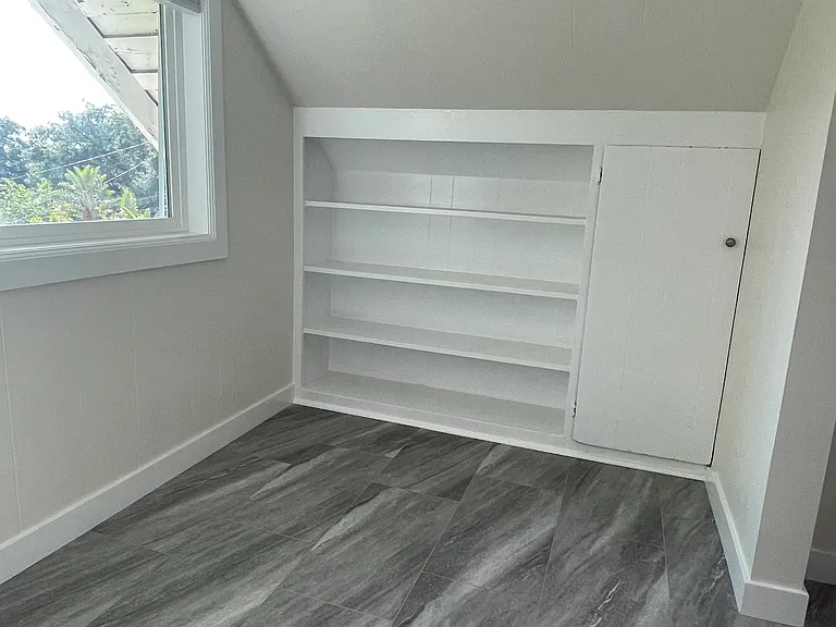 Breakfast nook looking West at shelves for storage.