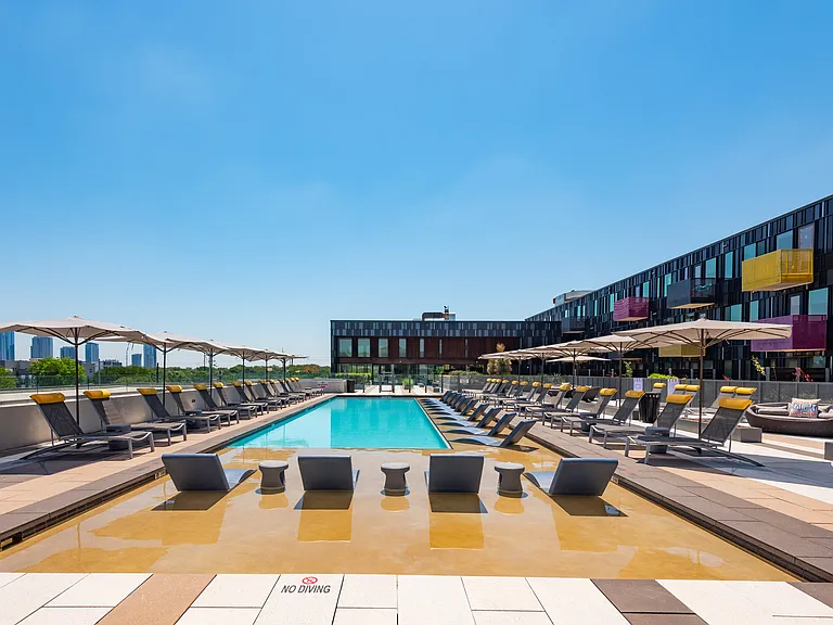 Outdoor Pool Area with Sun Loungers and Umbrellas for Elevated Comfort