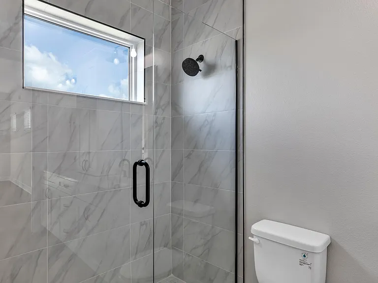 Shower and high up window to allow day light in.