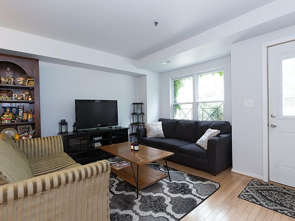 This is the entrance to your new home and the living room with two couches and a TV.