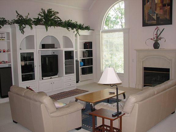 Airy and bright two story Grand Room featuring a wall of windows.