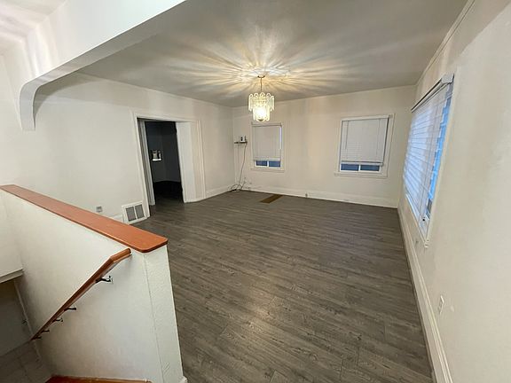 View of living room and staircase after entering front door