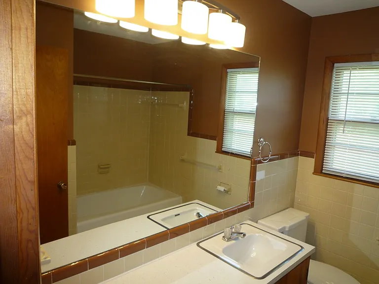 Hall bath vanity space with single sink.