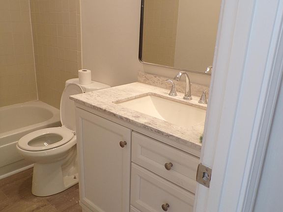 Master bath New luxury vinyl, new toilet, new vanity, new mirror, new lights