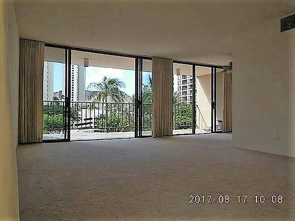 Living room looking at balcony (lanai), dining area and Diamond Head