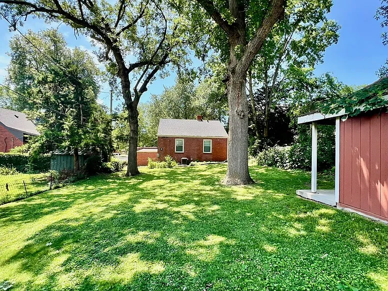 Beautiful trees create a shaded oasis with lots of green space.
