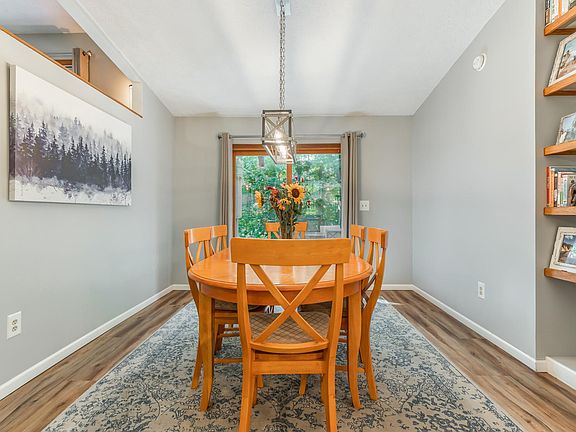 Dining Room - table seats 6. Dining room has floor to ceiling book shelf and a sliding glass door that goes out onto multi-level deck.