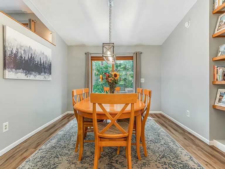 Dining Room - table seats 6. Dining room has floor to ceiling book shelf and a sliding glass door that goes out onto multi-level deck.