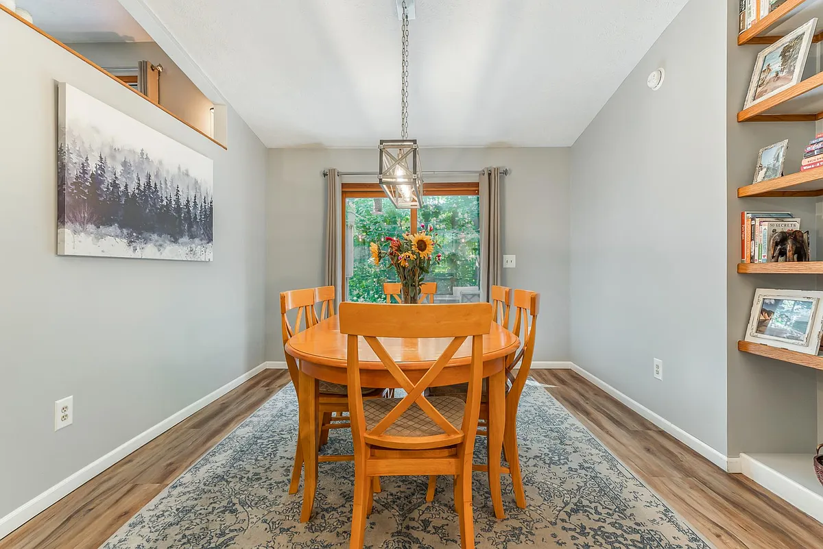 Dining Room - table seats 6. Dining room has floor to ceiling book shelf and a sliding glass door that goes out onto multi-level deck. - 5093 Jacks Trl