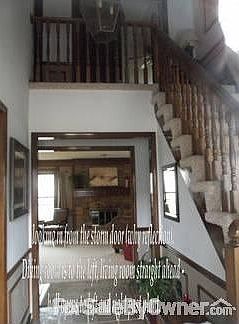 view from front door : all neutral colors with tile entry, hallway & kit. extensive moulding