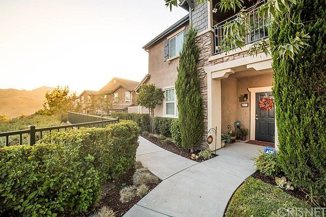 Front door of the home with setting sun in the dis