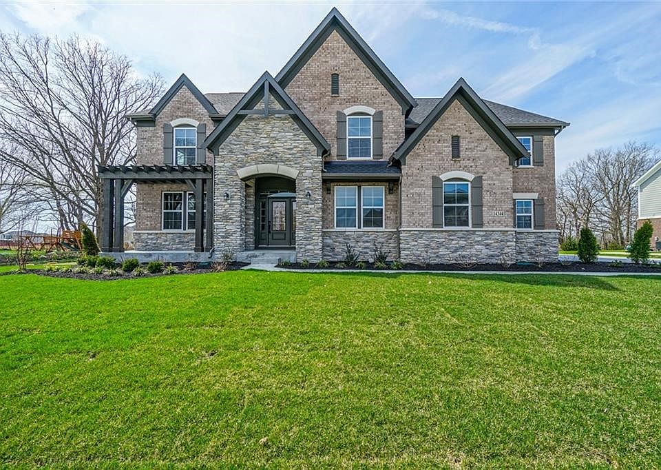 Elegant Elevation with Stone, Brick and Wood Pergola.