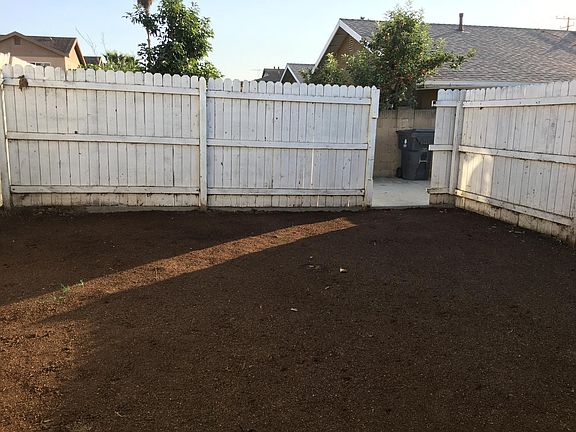 private fenced back yard, newly planted lawn