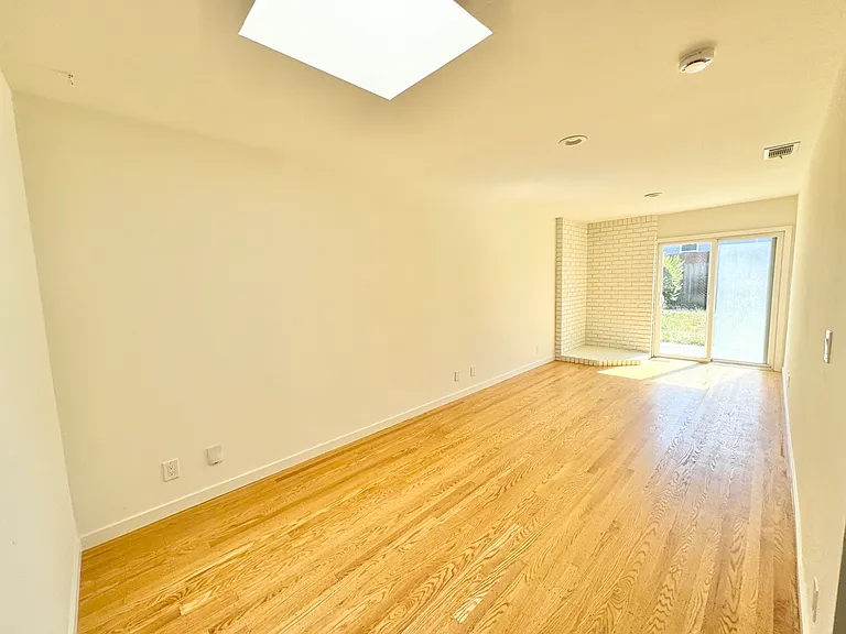 Family room offers flexibility for a media room, dining nook, home office, play area. Skylight provides lovely natural lighting. Access to backyard patio.