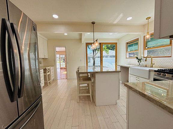 The kitchen is one of the pride and joy's of this home! It boasts stainless steel appliances, double oven, new dishwasher, imported Italian real stone island & countertops, extra large Andersen sliding doors. It is bright with good meals to be shared!