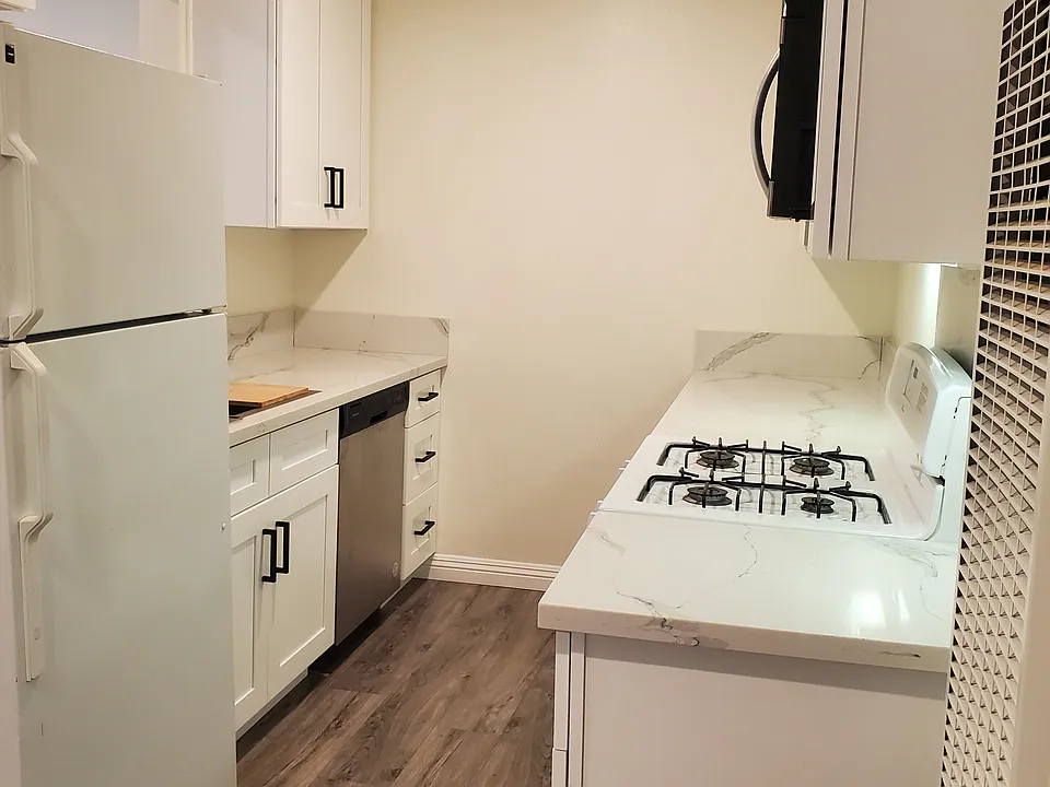 New Cabinets and flooring throughout apartment
